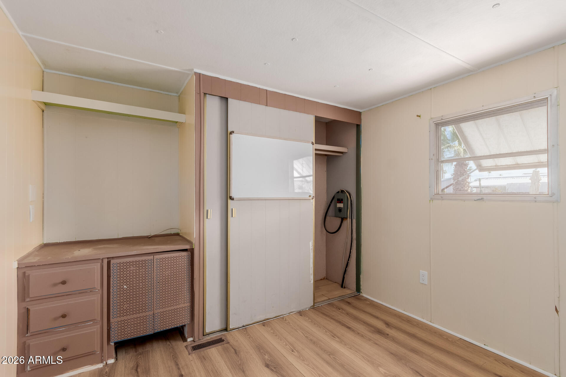 2434 East Main Street, Unit 123 Mesa, AZ 85213 - Photo 22 of 29 a view of an empty room with window and wooden floor