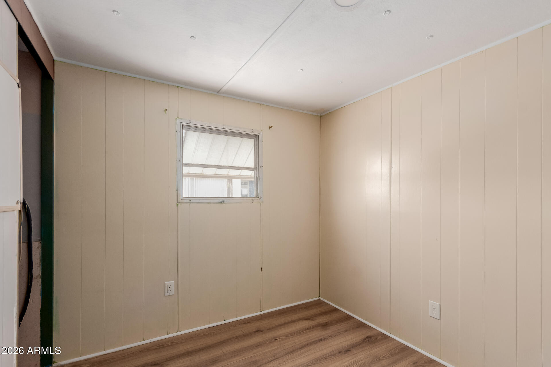 2434 East Main Street, Unit 123 Mesa, AZ 85213 - Photo 24 of 29 an empty room with wooden floor and windows
