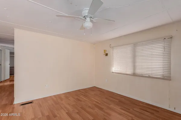 a view of empty room with wooden floor