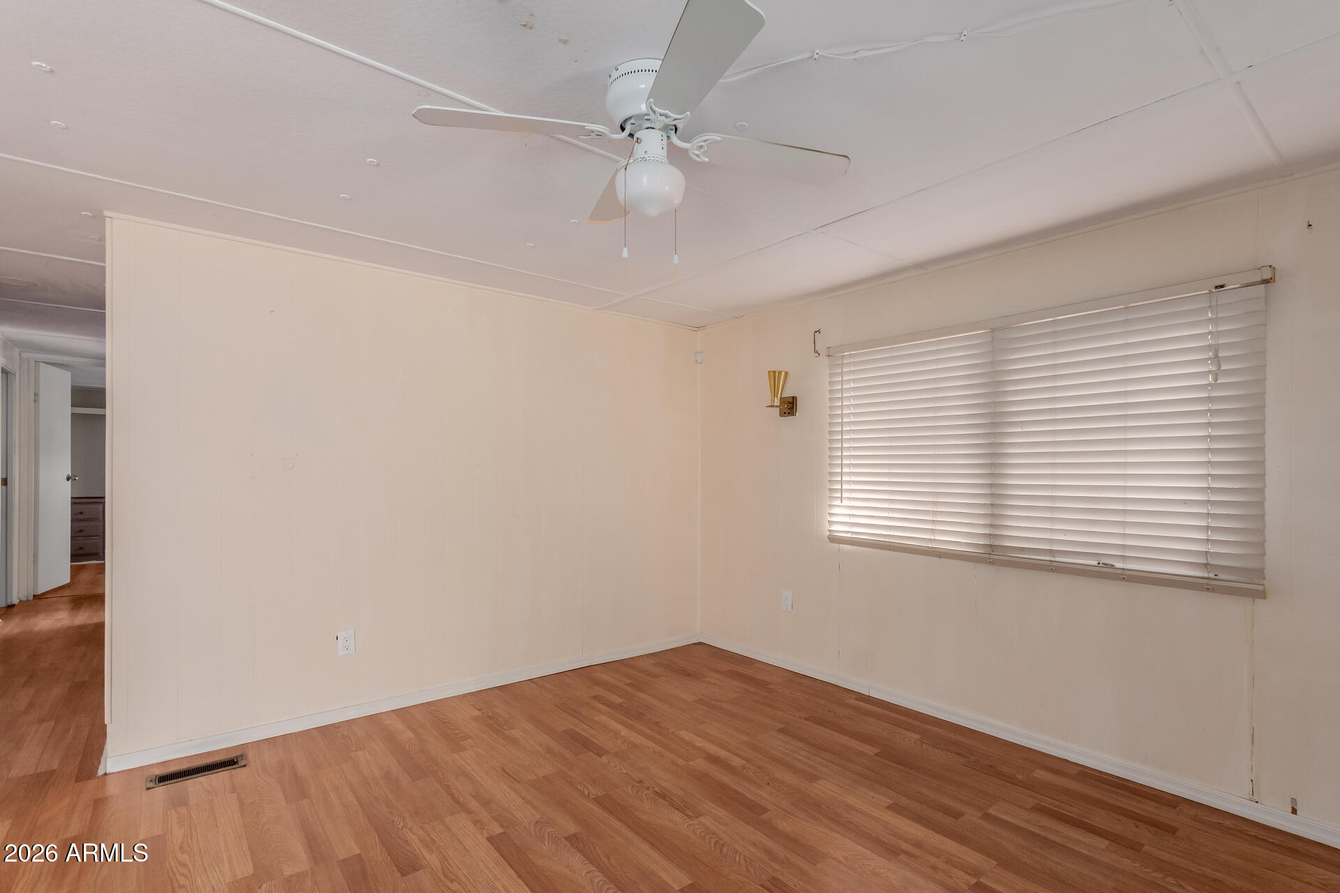2434 East Main Street, Unit 123 Mesa, AZ 85213 - Photo 8 of 29 a view of an empty room with wooden floor and a window