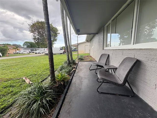 a balcony with table and chairs