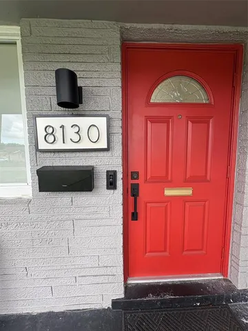 a view of a kitchen with furniture and an empty room