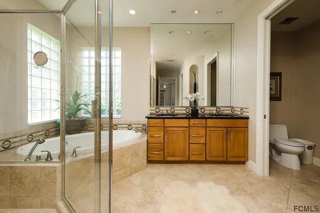 a spacious bathroom with a bathtub and a sink