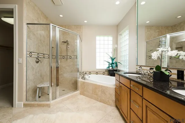 a spacious bathroom with a shower sink and mirror