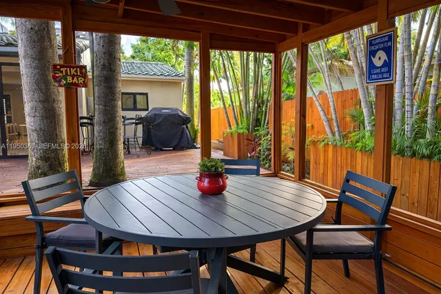 a view of a dining room with furniture wooden floor and a potted plant