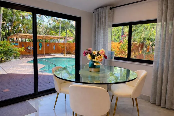 a dining room with a table and chairs