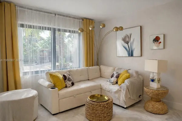 a living room with furniture and a large window