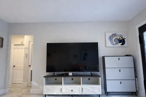 a room with painting on the wall and a table