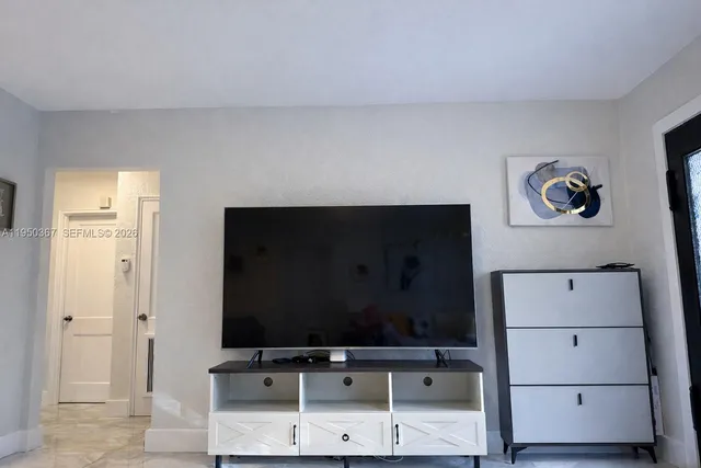 a room with painting on the wall and a table