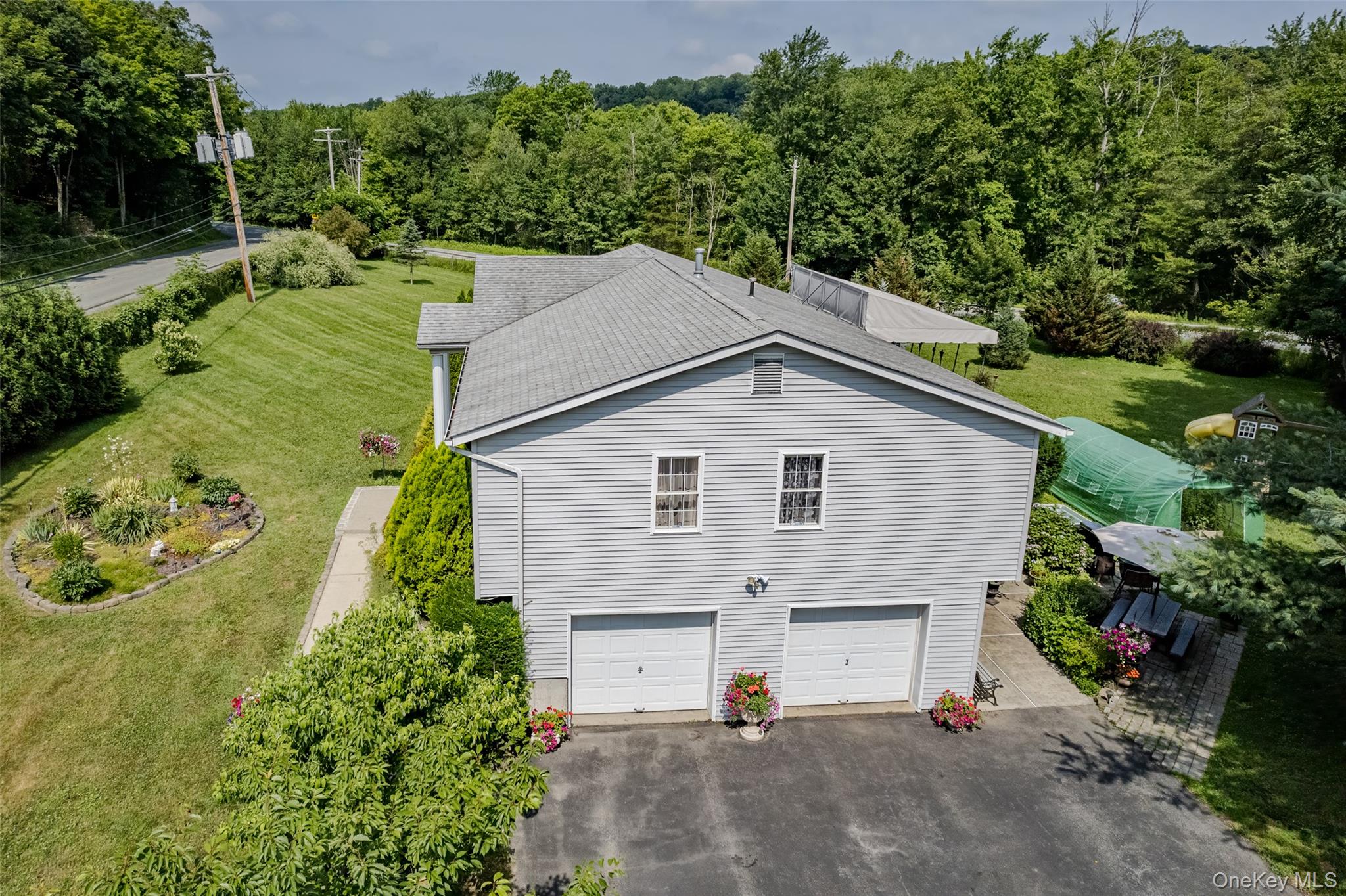 300 Mountain Lodge Road Monroe, NY 10950 - Photo 30 of 41 View of home's exterior with asphalt driveway, a garage, and a yard