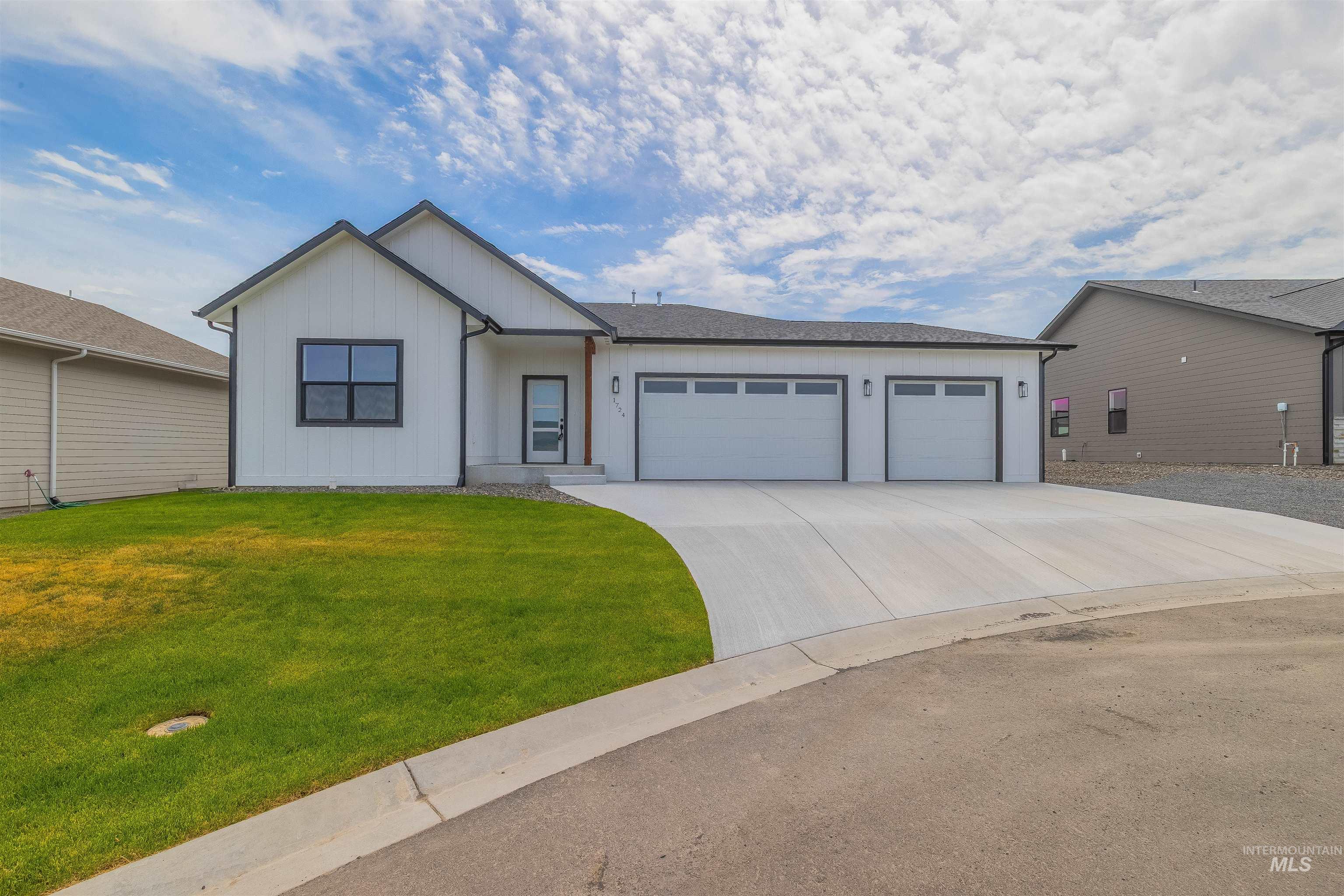 1724 Pathway Court Lewiston, ID 83501 - Photo 2 of 37 View of front of property featuring an attached garage, concrete driveway, board and batten siding, and a front yard