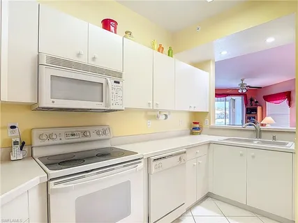 a kitchen with cabinets appliances a sink and a counter top space