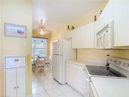 a kitchen with a sink cabinets and refrigerator