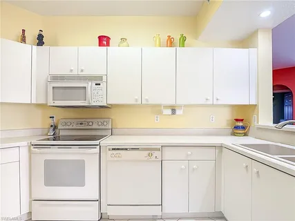 a kitchen with cabinets appliances and a sink