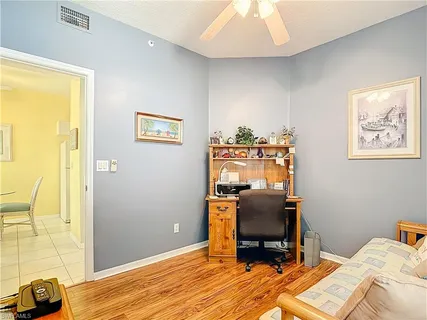 a view of a workspace with furniture and a window