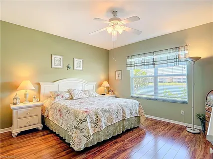 a bedroom with a bed wooden floor and a window