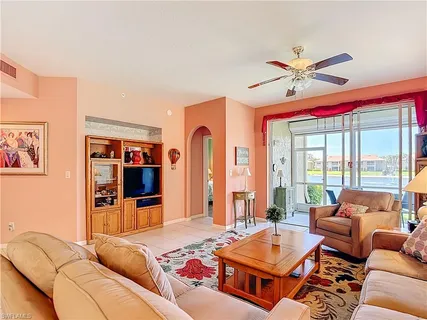 a living room with furniture and floor to ceiling window