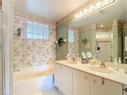 a bathroom with a bathtub sink and mirror
