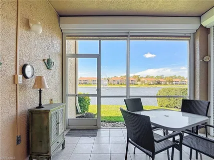 a dining room with furniture and a floor to ceiling window