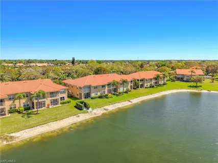 an aerial view of residential houses with outdoor space and river