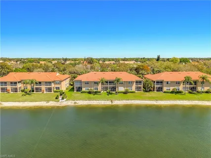 a view of a town with lawn chairs under an umbrella