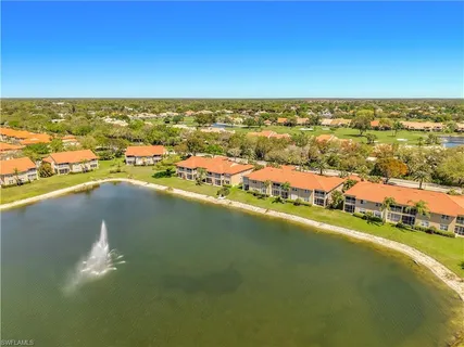 an aerial view of residential building and lake