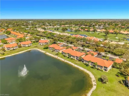 an aerial view of residential houses with outdoor space and ocean view