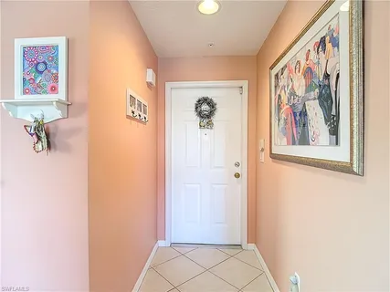 a view of a hallway with paintings on the wall
