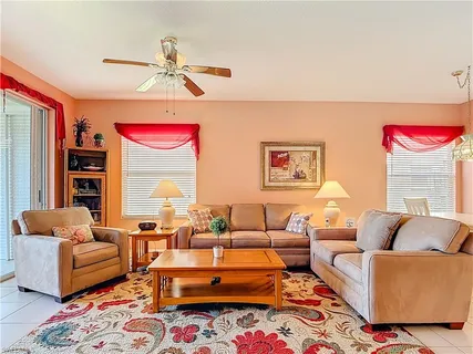 a living room with furniture a rug and a chandelier