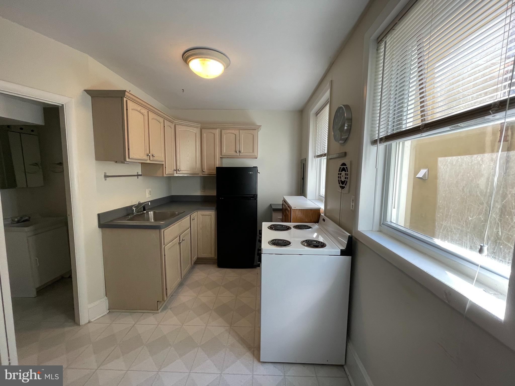 790 South Front Street Philadelphia, PA 19147 - Photo 5 of 12 a kitchen with stainless steel appliances granite countertop a refrigerator a sink and a stove