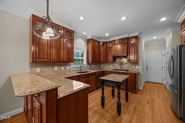 a view of a kitchen with granite countertop a stove and a refrigerator