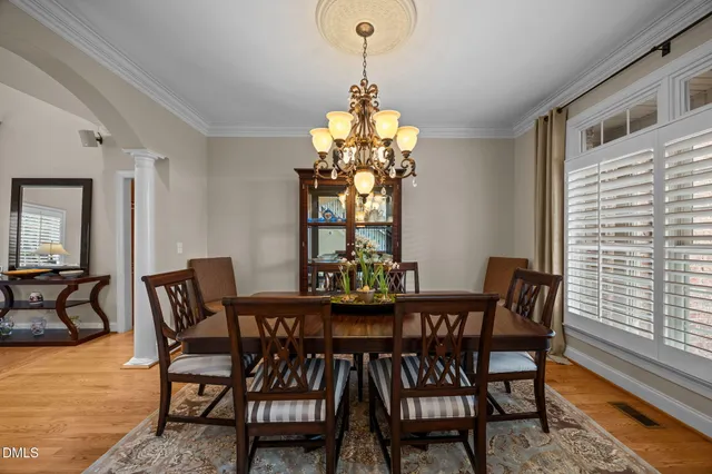a dining room with furniture a rug and a chandelier