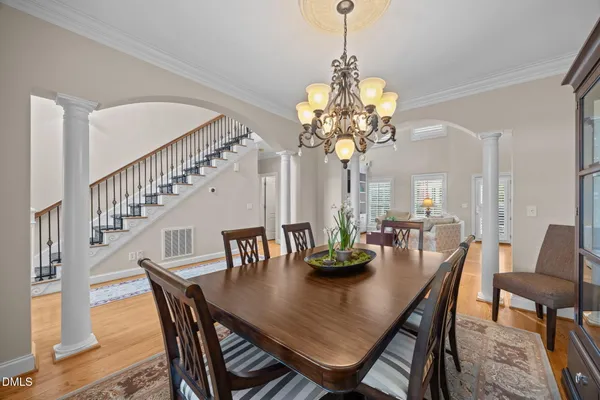 a view of a dining room with furniture and chandelier