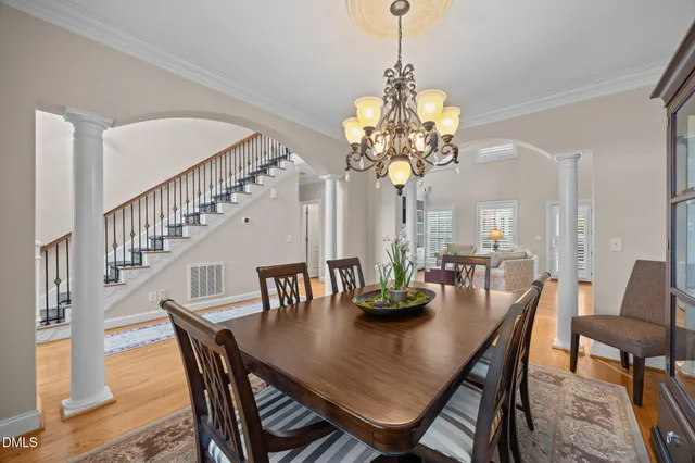 a view of a dining room with furniture and chandelier