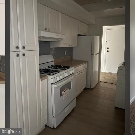 a kitchen with cabinets and a stove