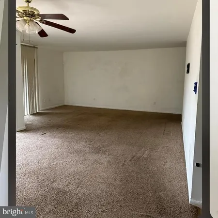 a view of a room with a ceiling fan