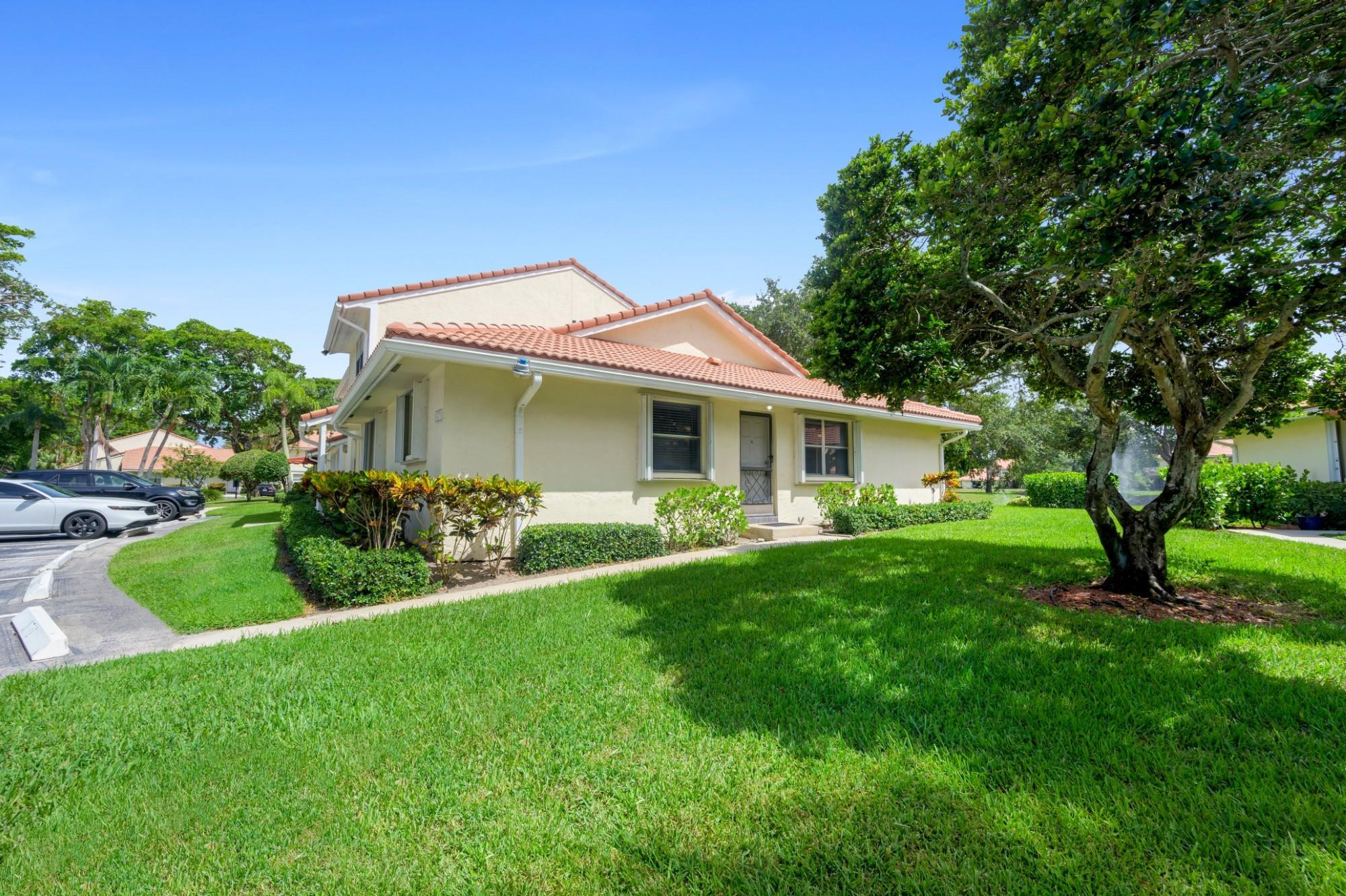 6371 Boca Circle Boca Raton, FL 33433 - Photo 4 of 24 a front view of a house with a garden