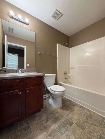 a bathroom with a sink toilet and a mirror