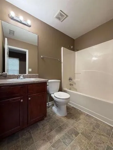 a bathroom with a sink toilet and a mirror