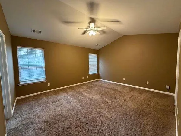 a view of an empty room with a ceiling fan