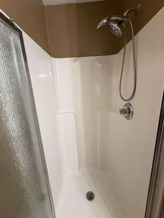 a bath tub sitting in a bathroom next to a window