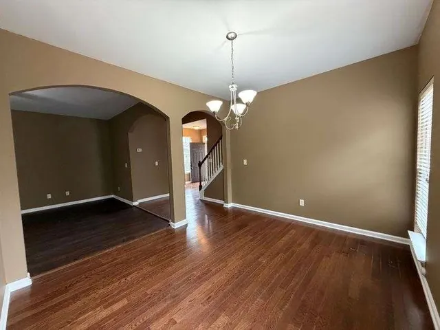 a kitchen with stainless steel appliances a refrigerator and a stove top oven