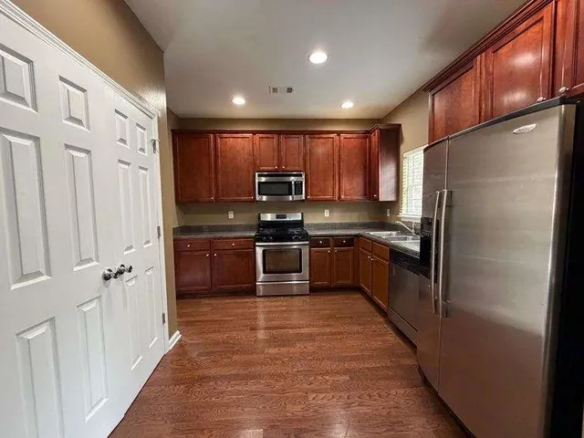 a view of a hallway with wooden floor