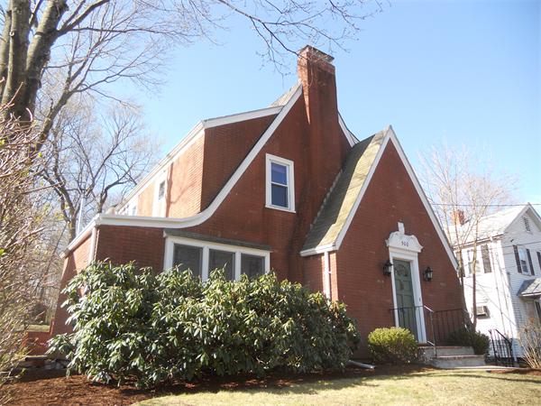 500 Marrett Road Lexington, MA 02421 - Photo 1 of 16 a view of a brick house with large windows and a yard