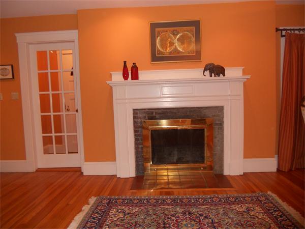 500 Marrett Road Lexington, MA 02421 - Photo 5 of 16 a view of an empty room with wooden floor and a fireplace