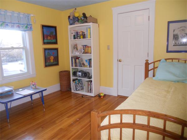 500 Marrett Road Lexington, MA 02421 - Photo 10 of 16 a bedroom with a bed and a bookshelf