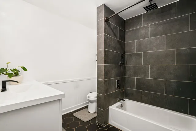 a bathroom with a bathtub and sink