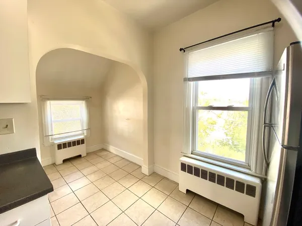 a kitchen with granite countertop a refrigerator and a stove top oven