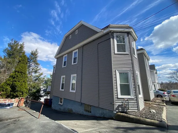 a view of a house with brick walls