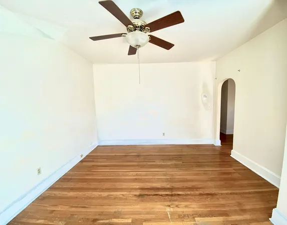a view of a room with wooden floor